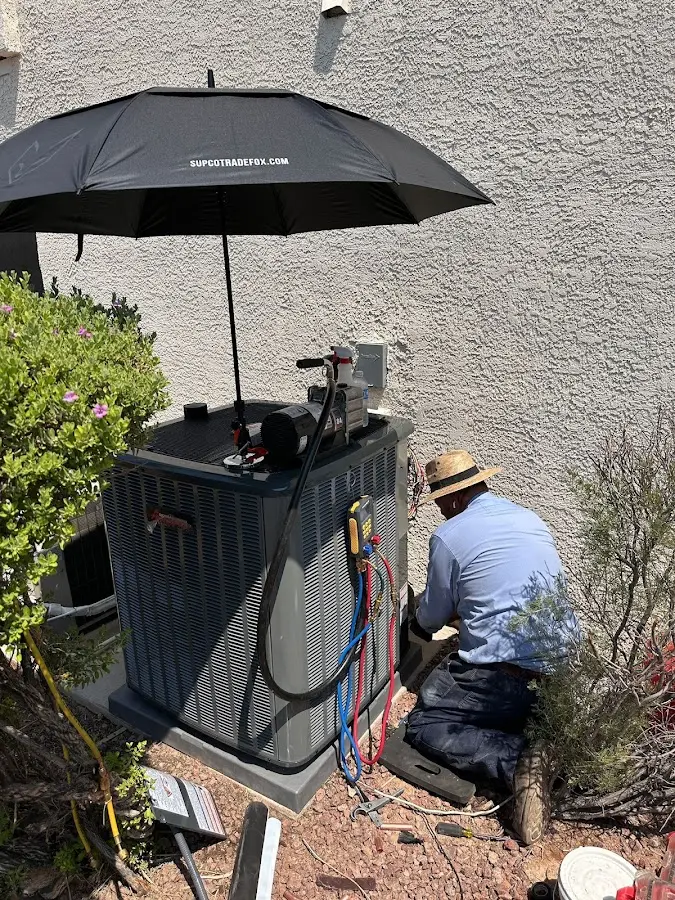HVAC technician performing outdoor AC maintenance in West Carrollton